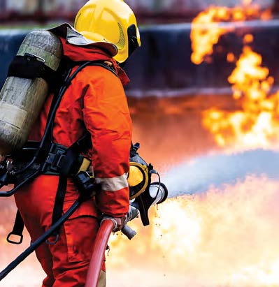 Firefighter spraying hose