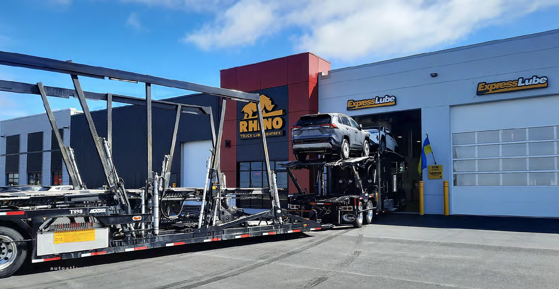 Truck loaded with cars entering a Rhyno workshop bay