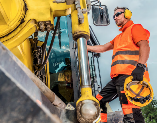 Man standing beside machinery