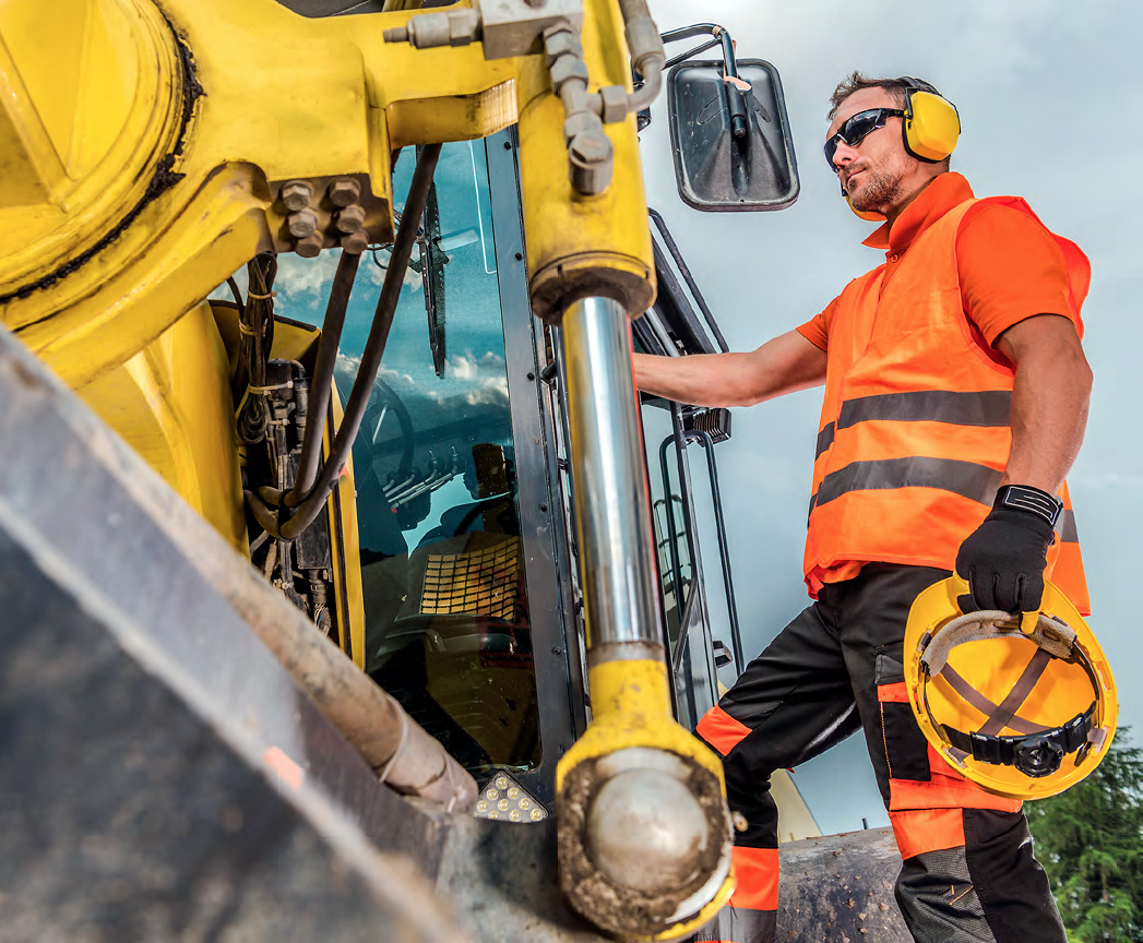 Man standing beside machinery