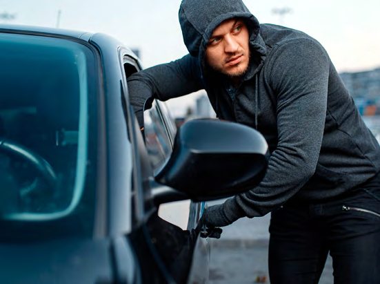 Man Breaking Into Car Window