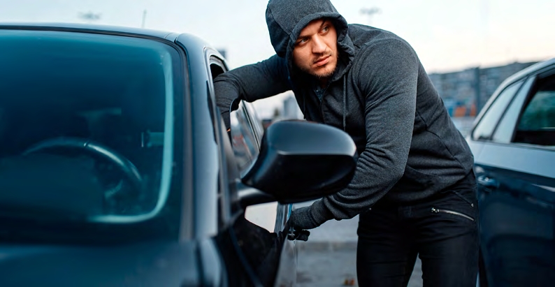 Man Breaking Into Car Window