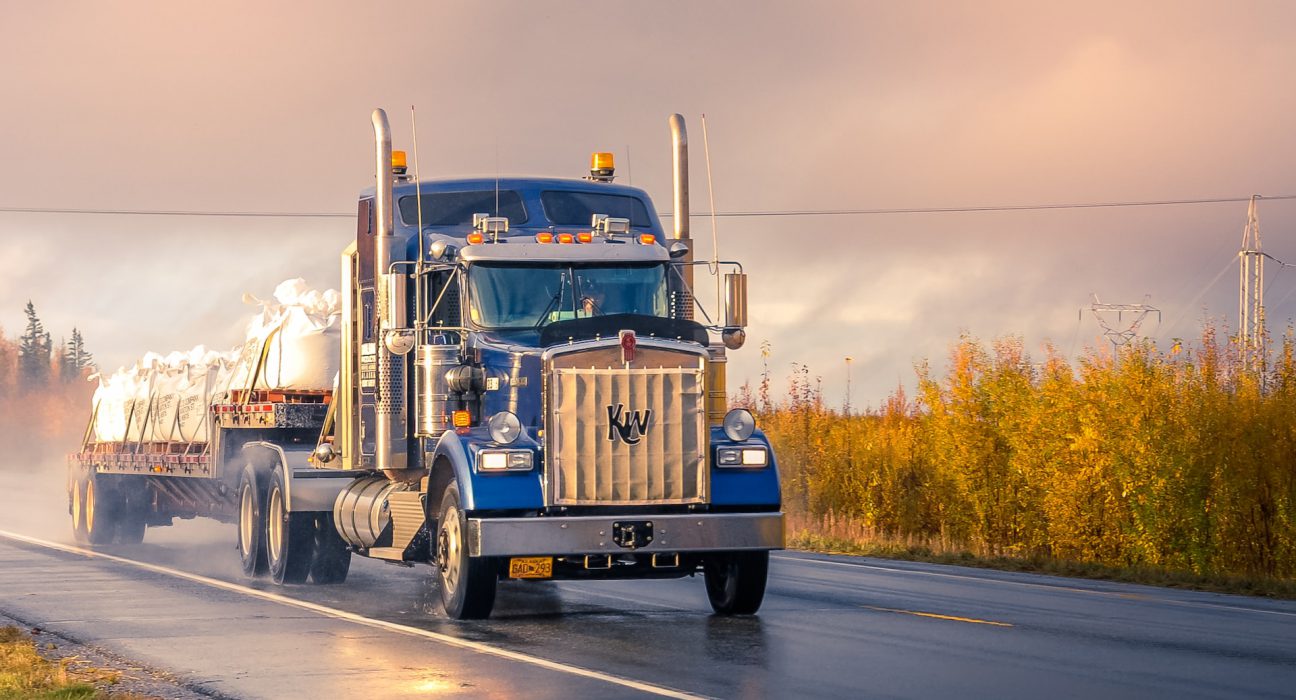 A semi-truck carrying bags.