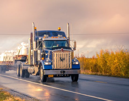 A semi-truck carrying bags.